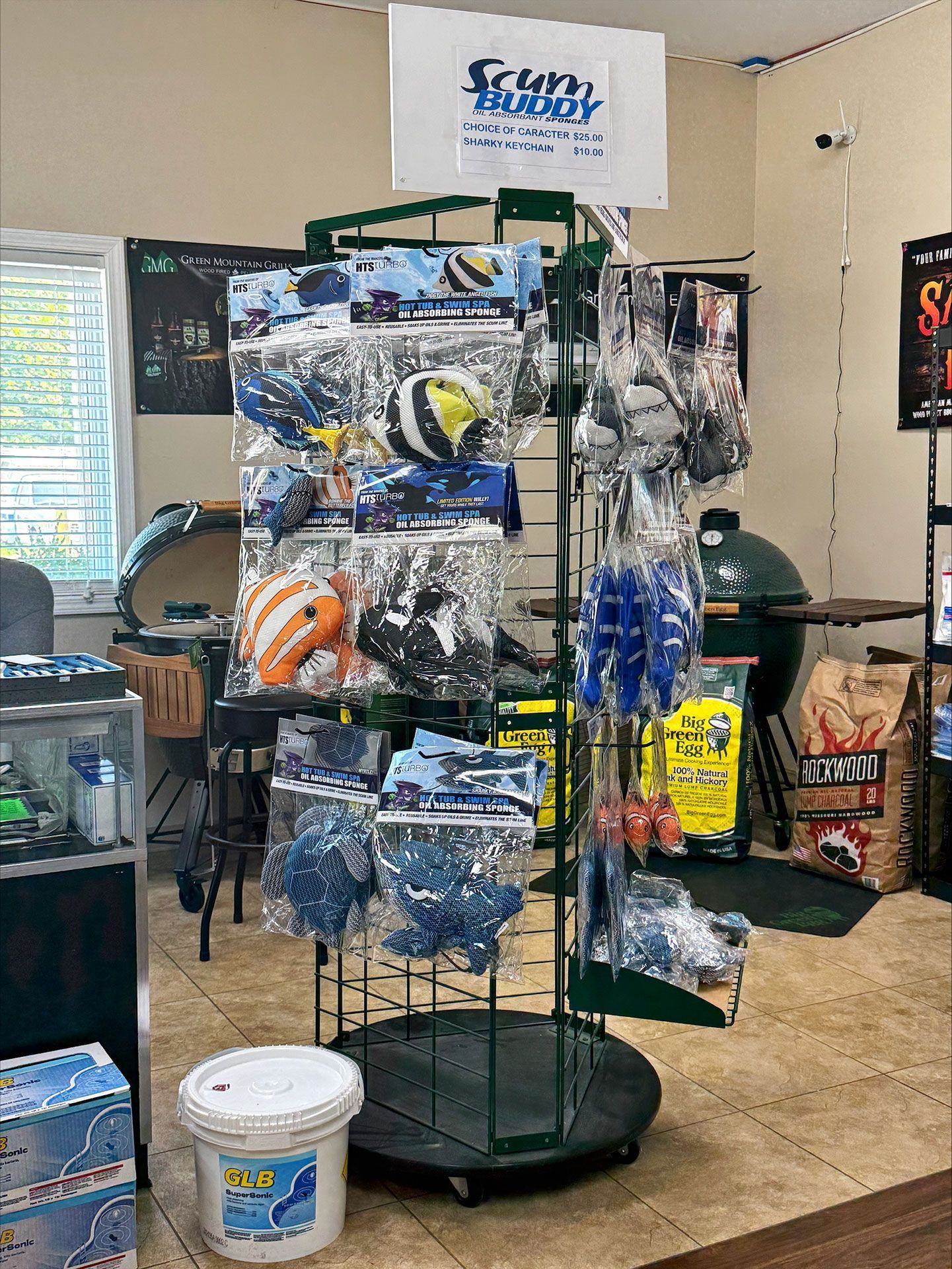 Spinning display rack with packaged pool accessories in a store.