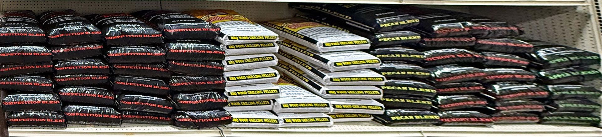 Shelves stacked with various colored bags, possibly products, in a store setting.