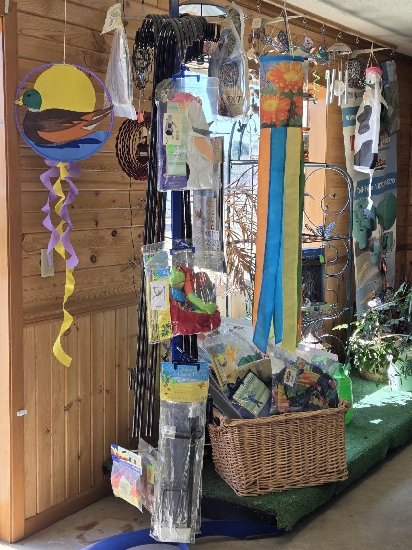 A bunch of bags of food are sitting on top of hay bales