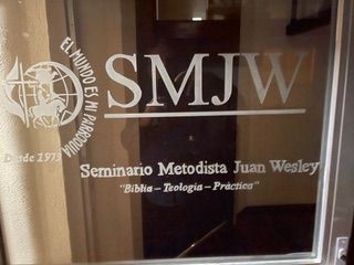 A glass door with SMJW written on it.