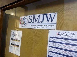 A bulletin board with a sign that says SMJW on it.