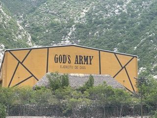 A yellow building with the words God's army on it.