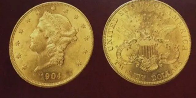 Two gold coins: a 1904 twenty-dollar U.S. gold piece, showing the bust of Liberty and an eagle.