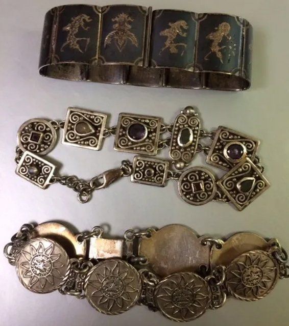 Three silver bracelets with various designs: linked panels, squares with stones, and round medallions.