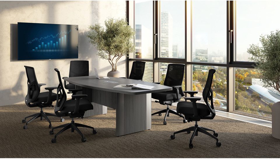 Modern conference room with black chairs, a gray table, wall screen, and floor-to-ceiling windows