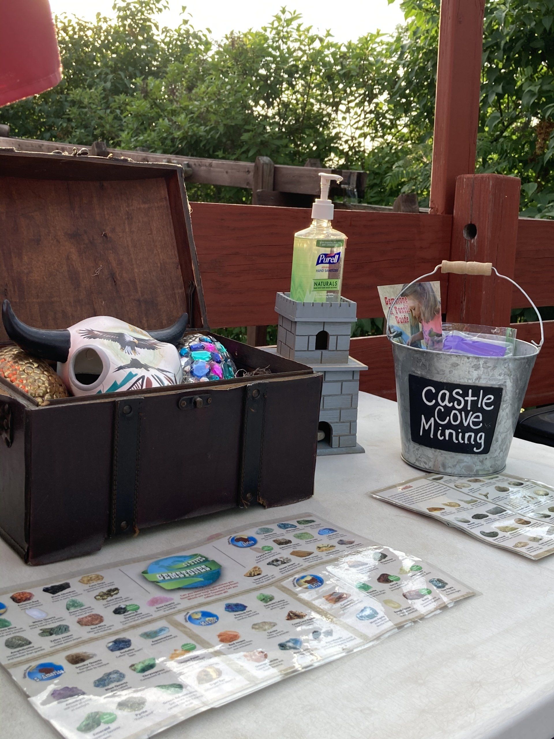 A table with a treasure chest and a bucket that says castle gravel mining