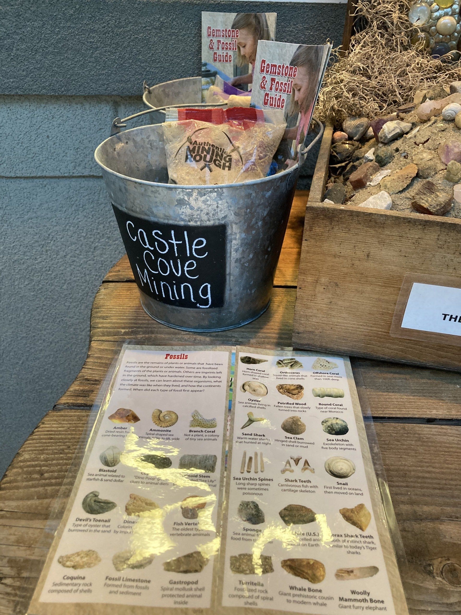 A bucket of castle stone mining is sitting on a wooden table.