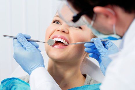Woman having teeth examined at dentist's office