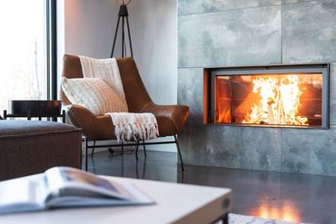 A living room with a fireplace and a chair