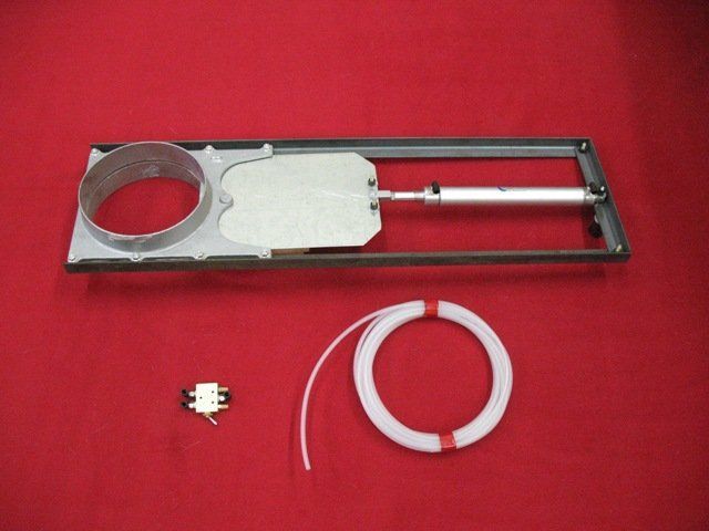 A piece of metal with a hose attached to it on a red surface