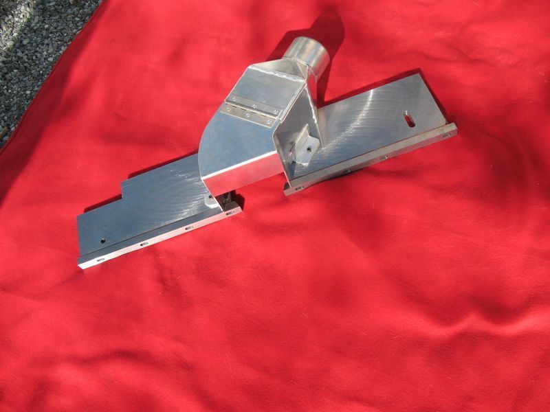 A metal object is laying on a red cloth