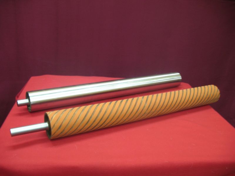 Two rollers are sitting on a red table cloth