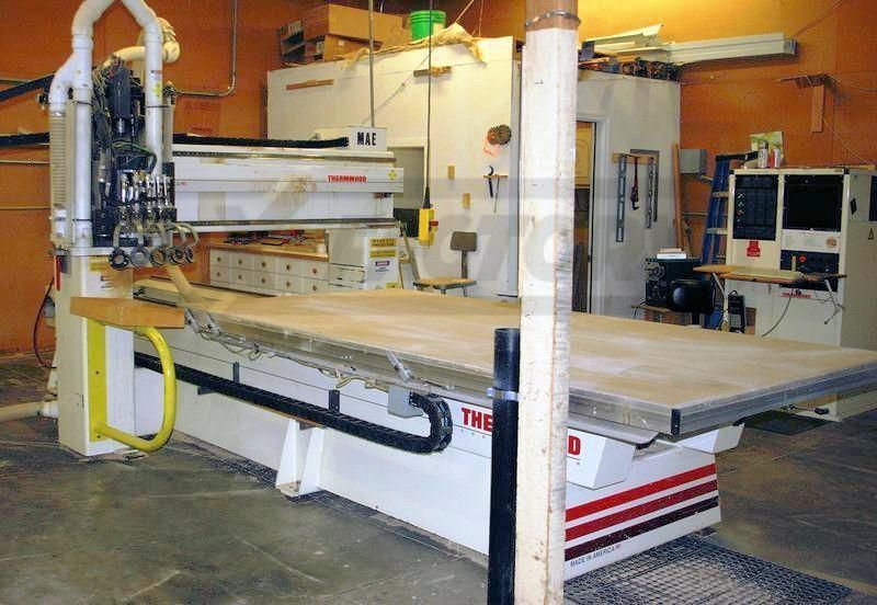 A large machine is sitting in a room with a sign that says the d on it