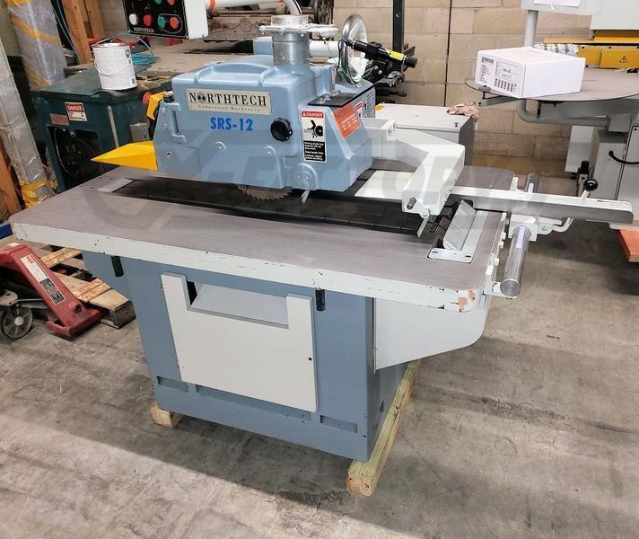 A blue and white machine is sitting on top of a wooden table.