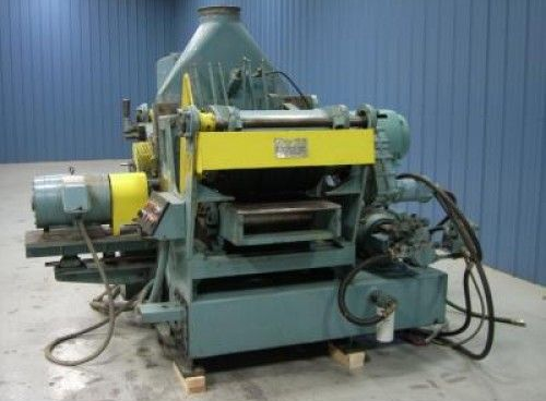 A machine is sitting on a wooden pallet in a room.