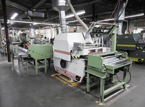 A machine is sitting in the middle of a factory.