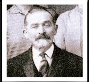 A black and white photo of a man in a suit and tie.