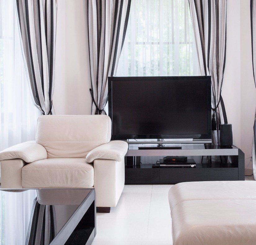 A living room with a television and a chair