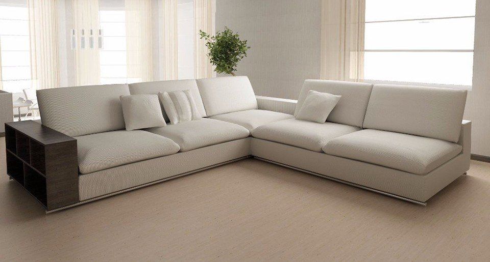 A living room with a large white sectional couch