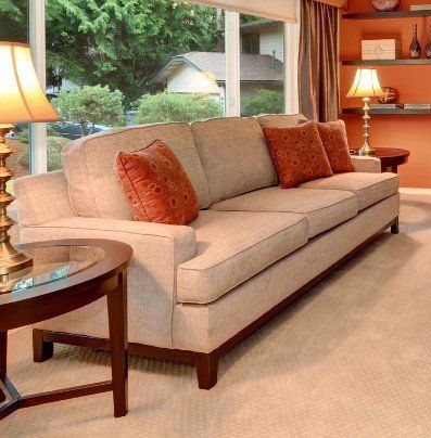 A living room with a couch and two lamps