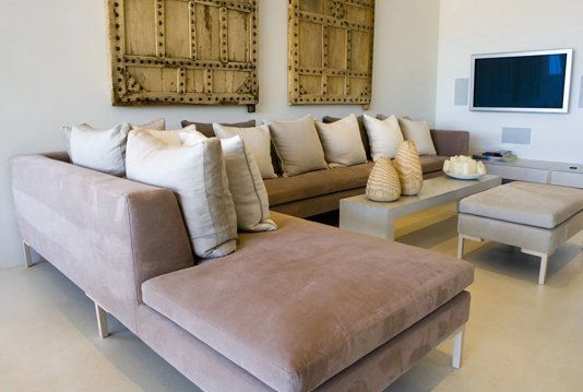 A living room with a large couch and a flat screen tv