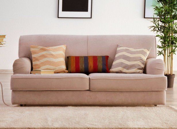 A living room with a couch and pillows on it