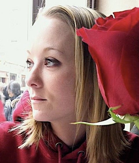 A woman with a red rose in her hair