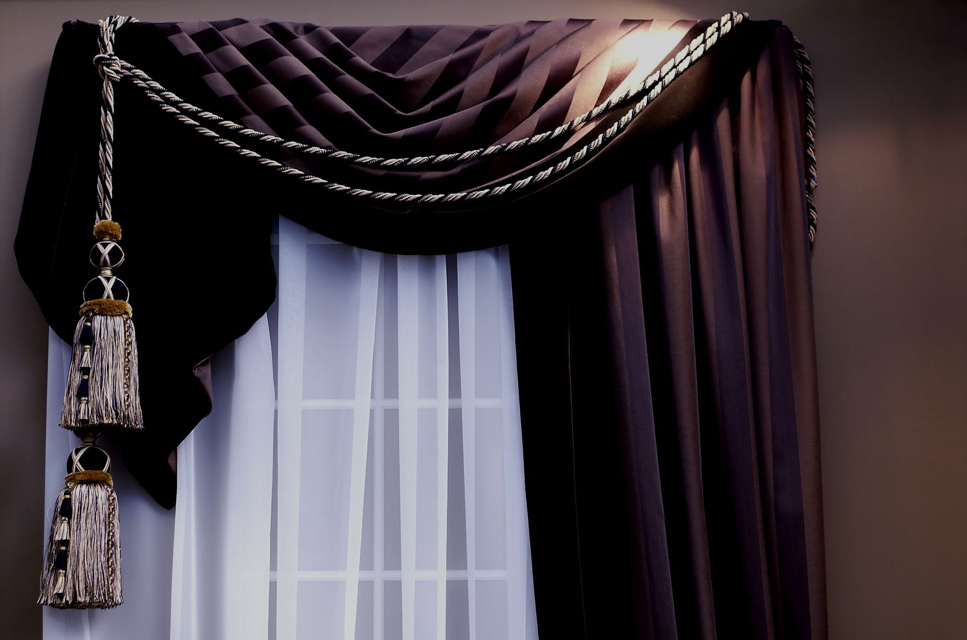 A window with purple curtains and white sheer curtains