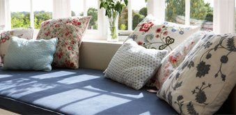 A window seat with lots of pillows on it