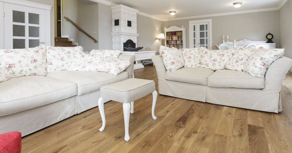 A living room with two couches , a table , and a fireplace.