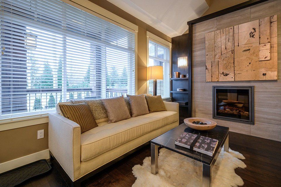 A living room with a couch , coffee table and fireplace