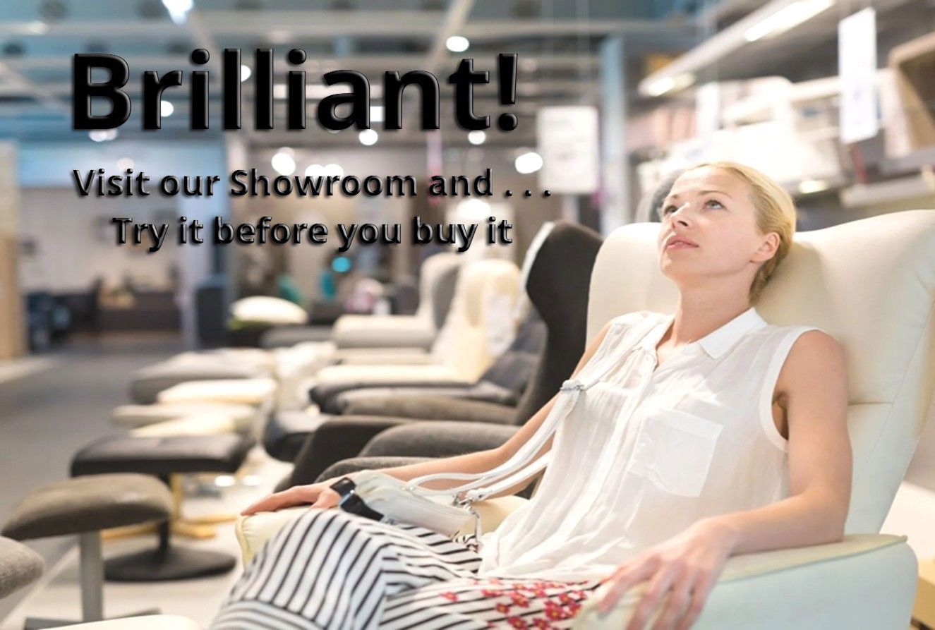 A woman is sitting in a chair in a furniture store.