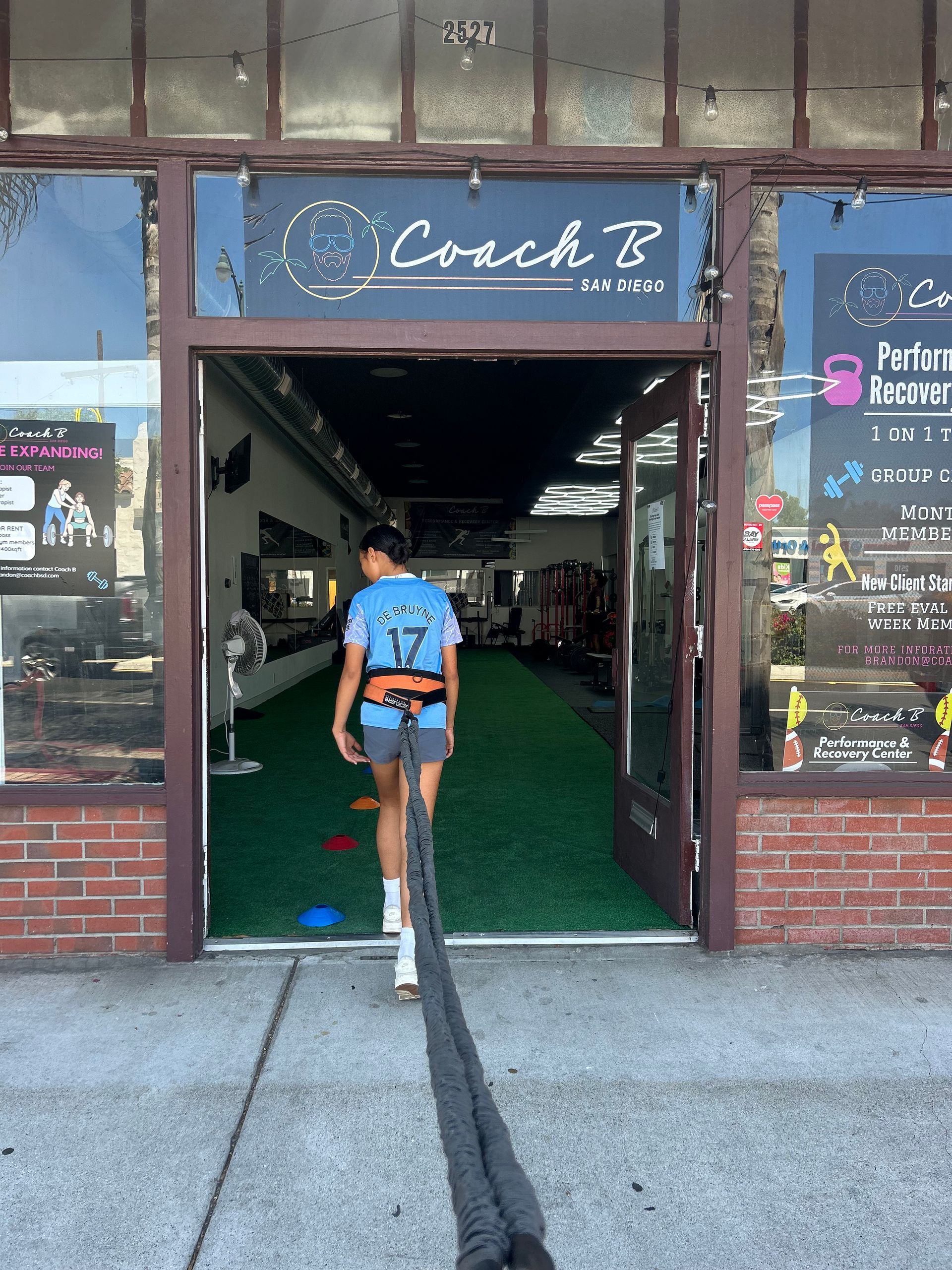 A person wearing a blue shirt with the number 12 on it