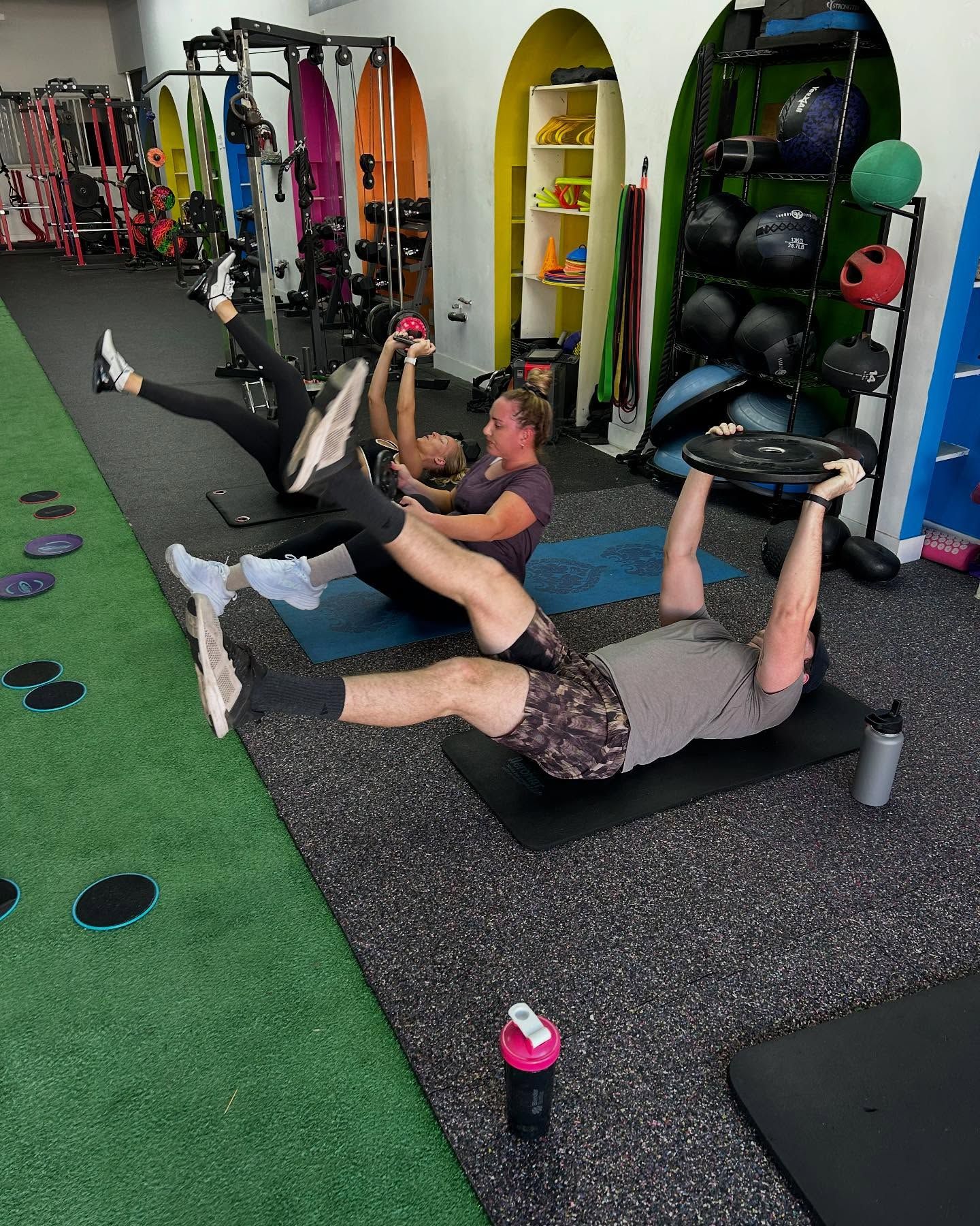 A group of people are doing exercises in a gym.