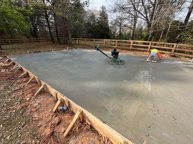 A man is working on a concrete floor with a machine.
