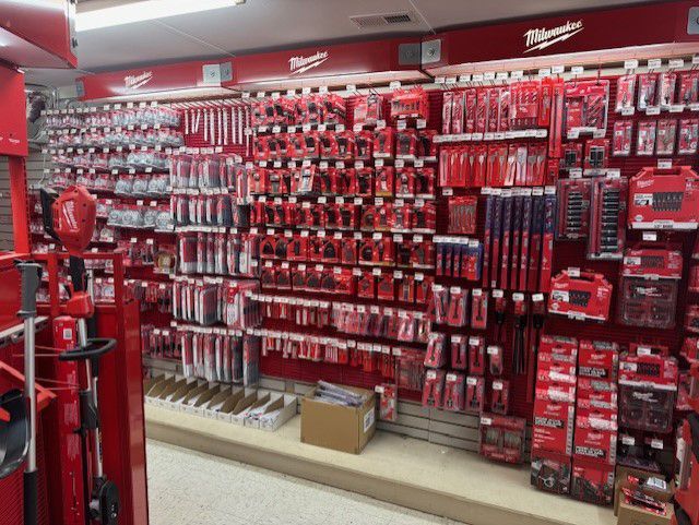 The inside of a milwaukee tool store filled with lots of red tools