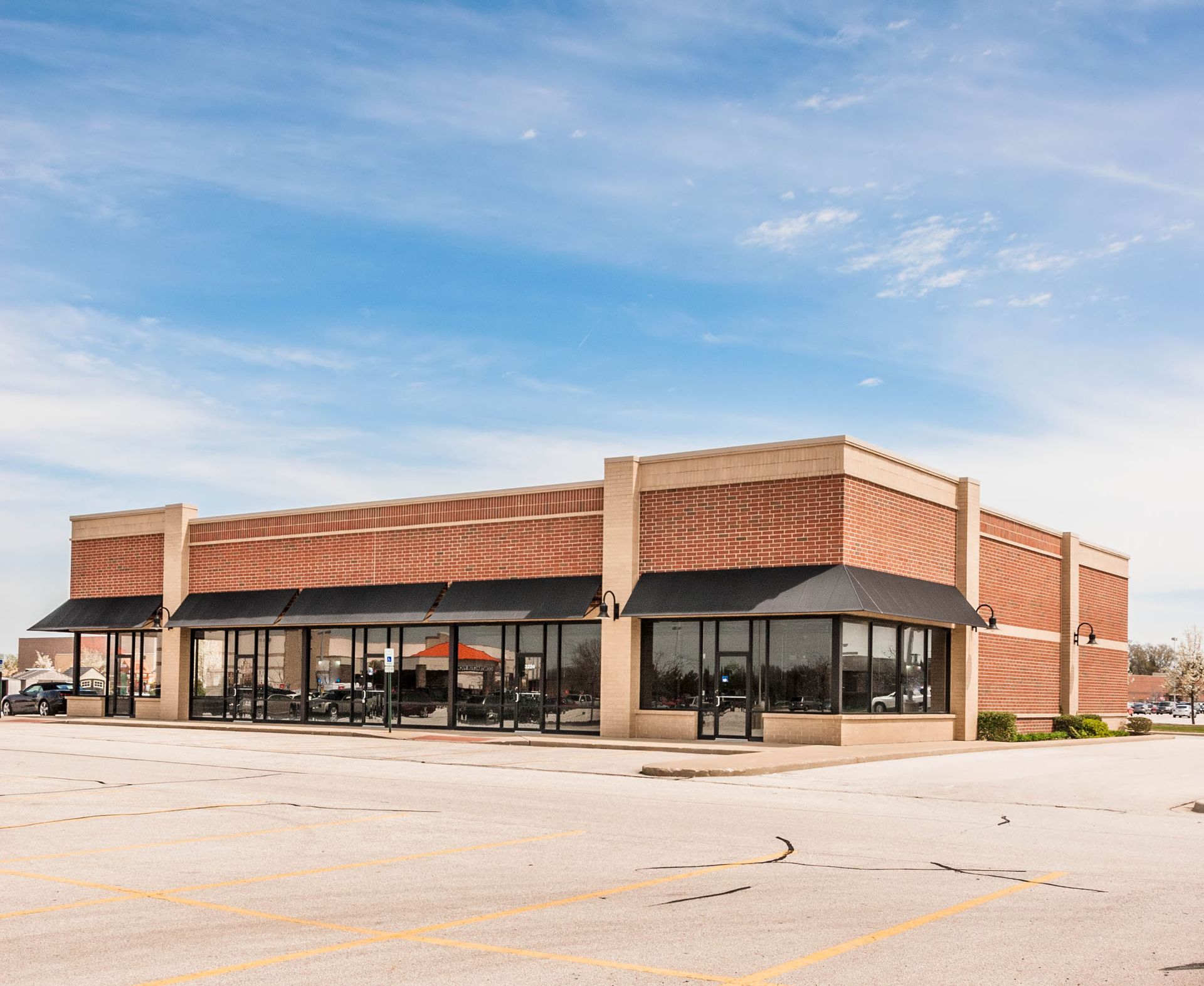 A large brick building with a parking lot in front of it