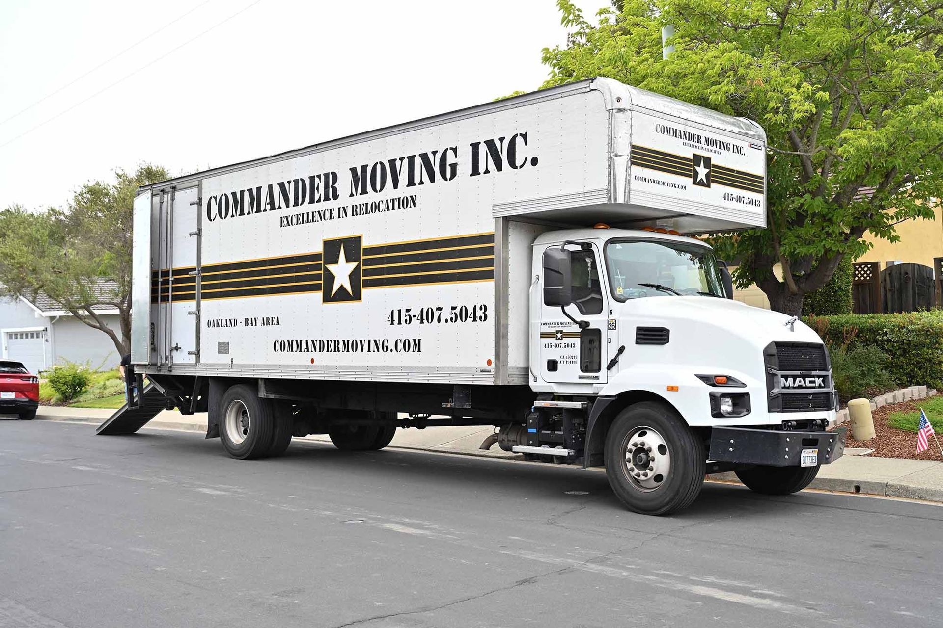 White moving truck on a street with 