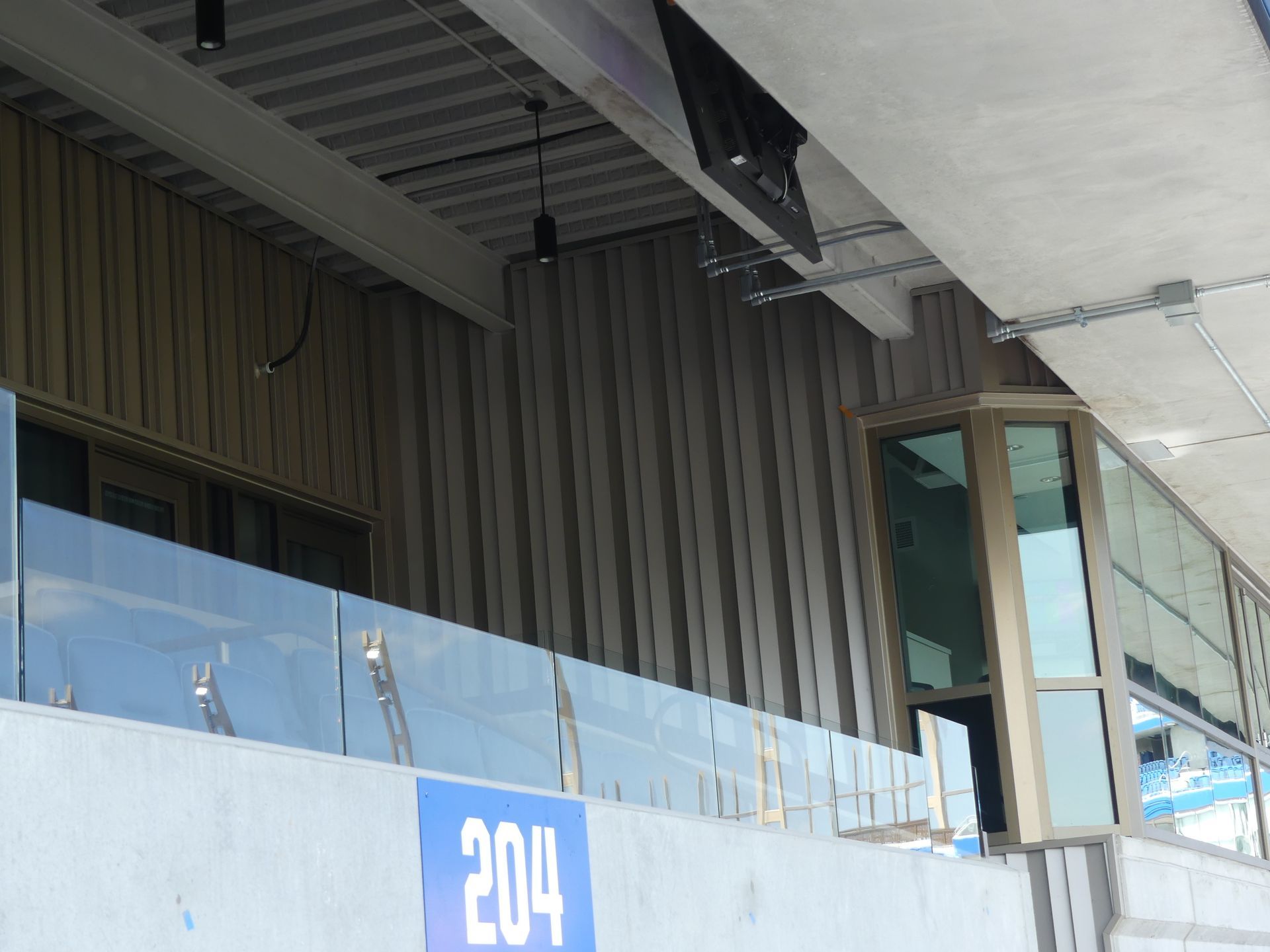 Exterior view of a modern building with windows, wooden panels.
