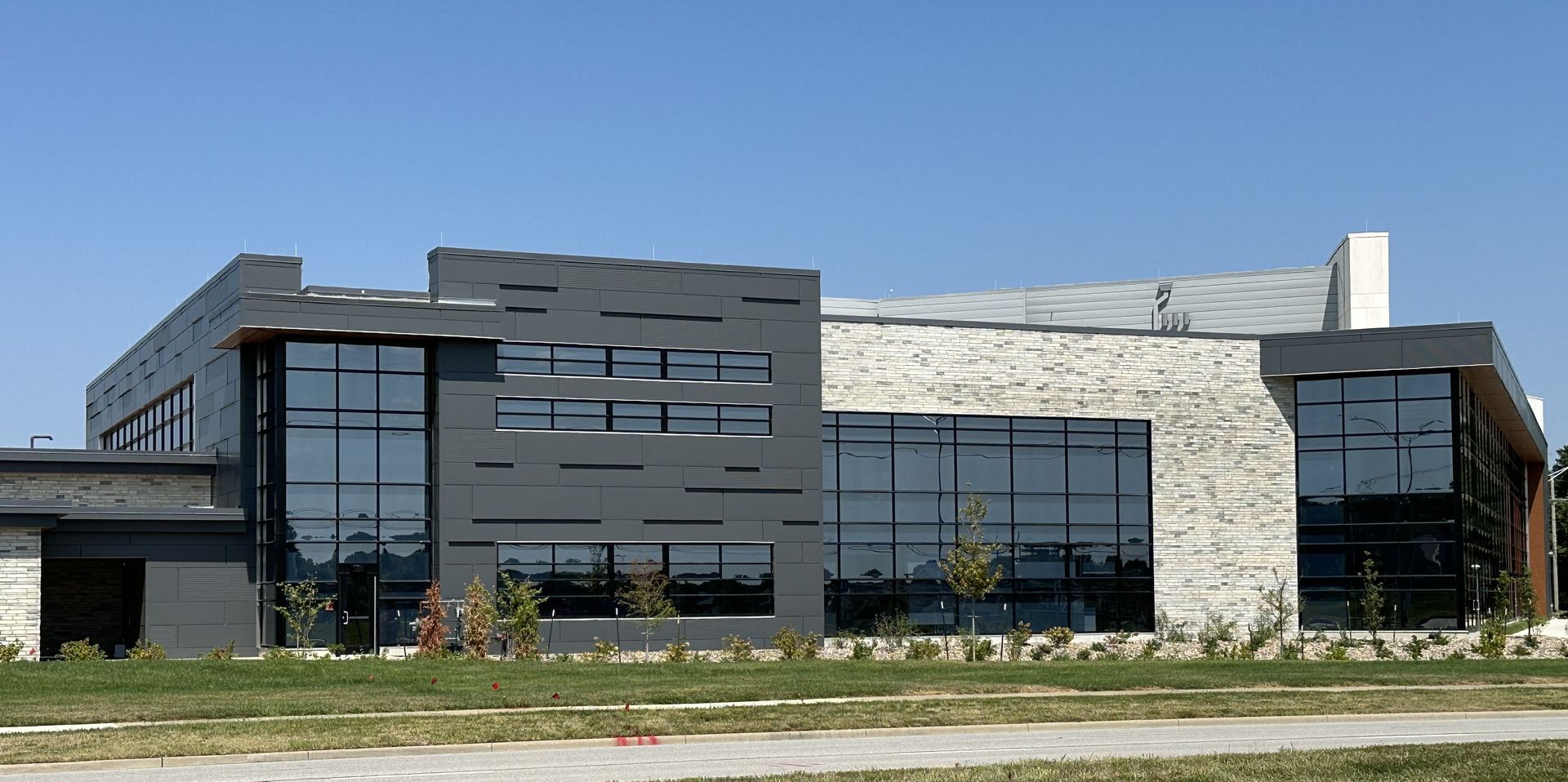 A large building with a lot of windows and a blue sky in the background
