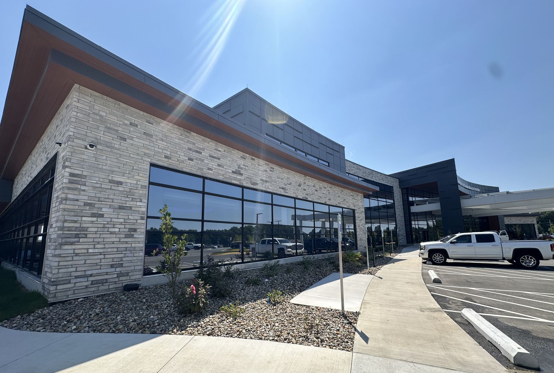 A large building with a lot of windows and a truck parked in front of it.
