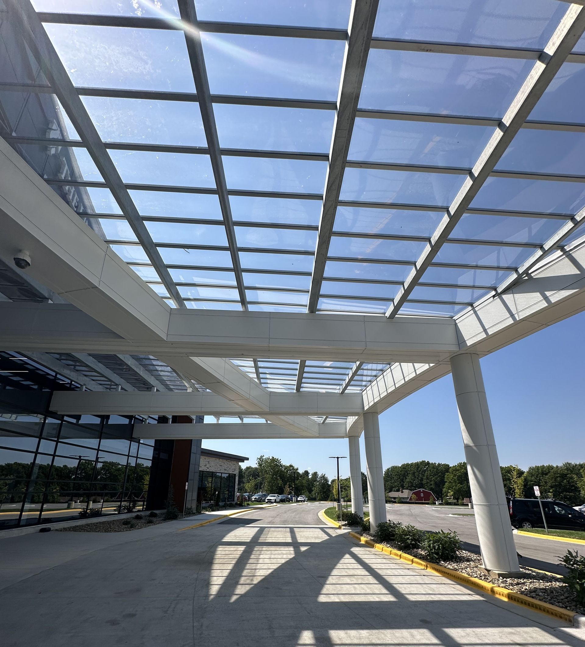 A building with a glass roof and a walkway leading to it.