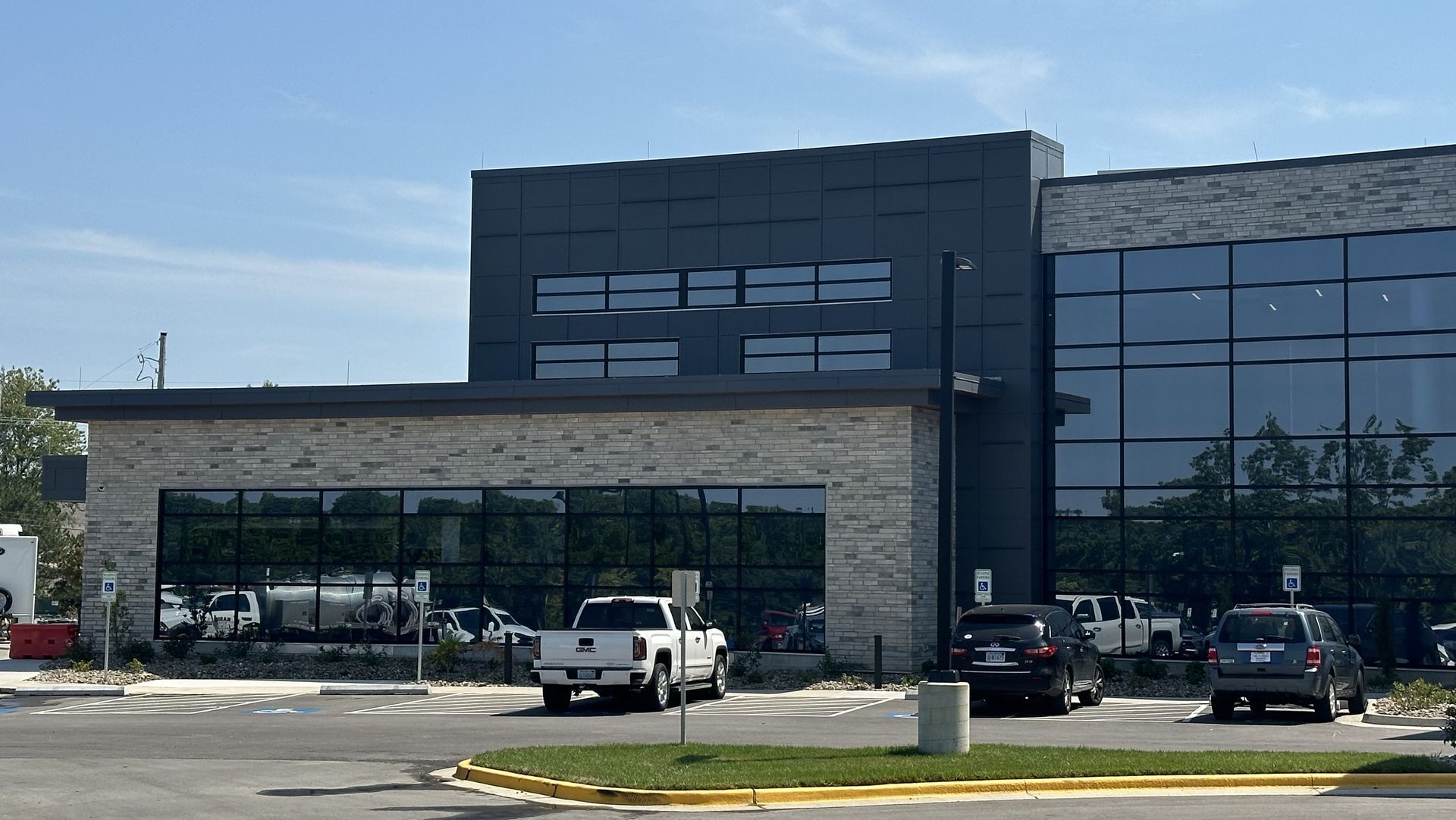 A truck is parked in front of a large building