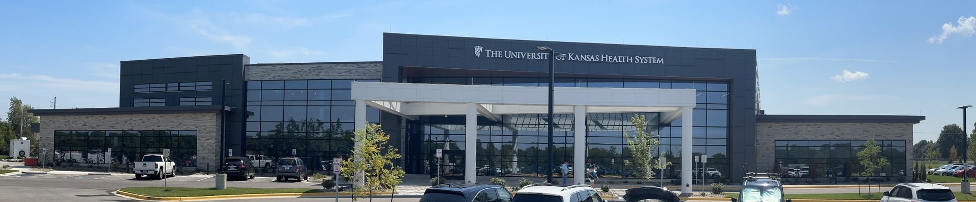 A large building with cars parked in front of it