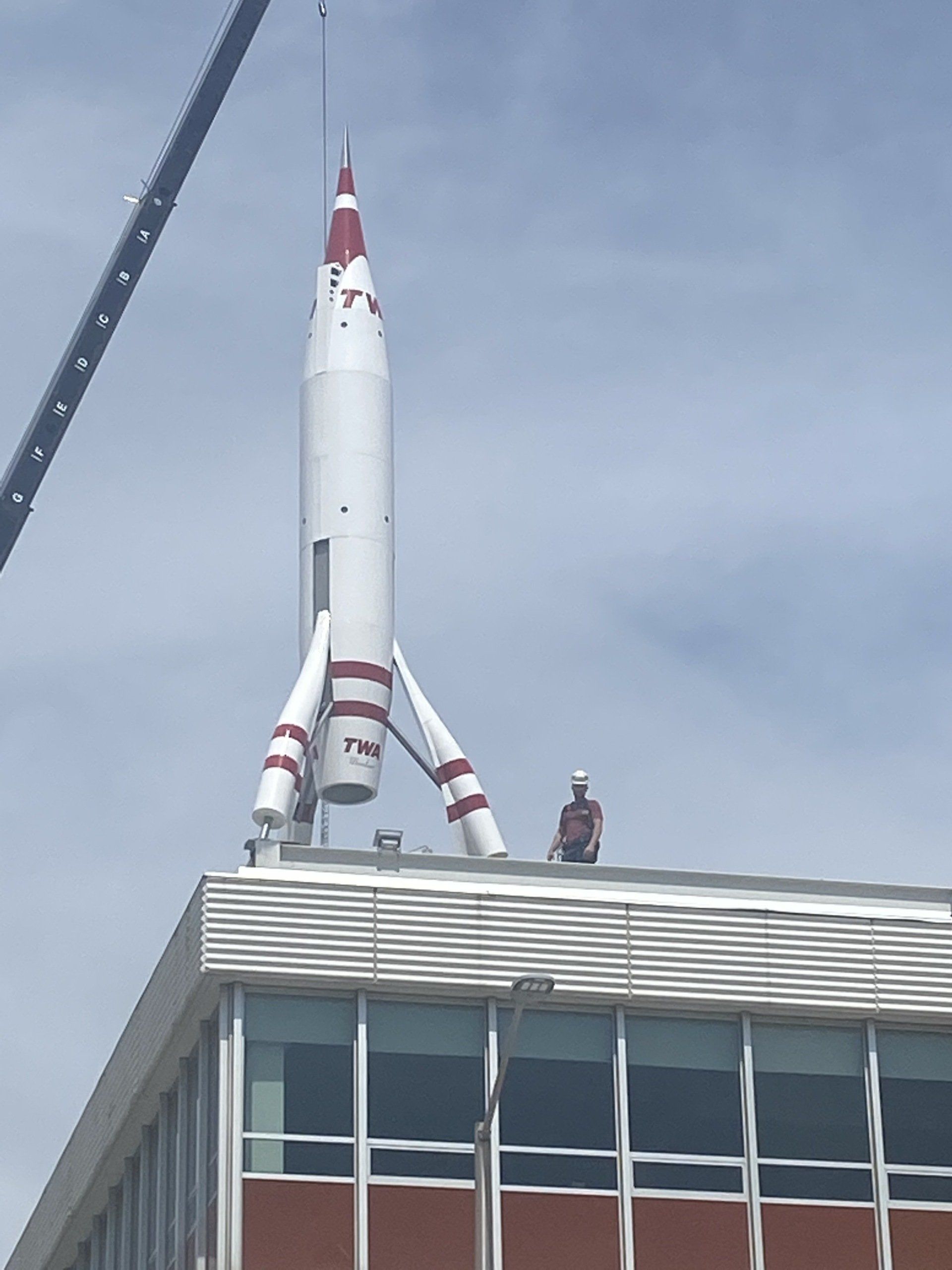 A rocket is being built on top of a building