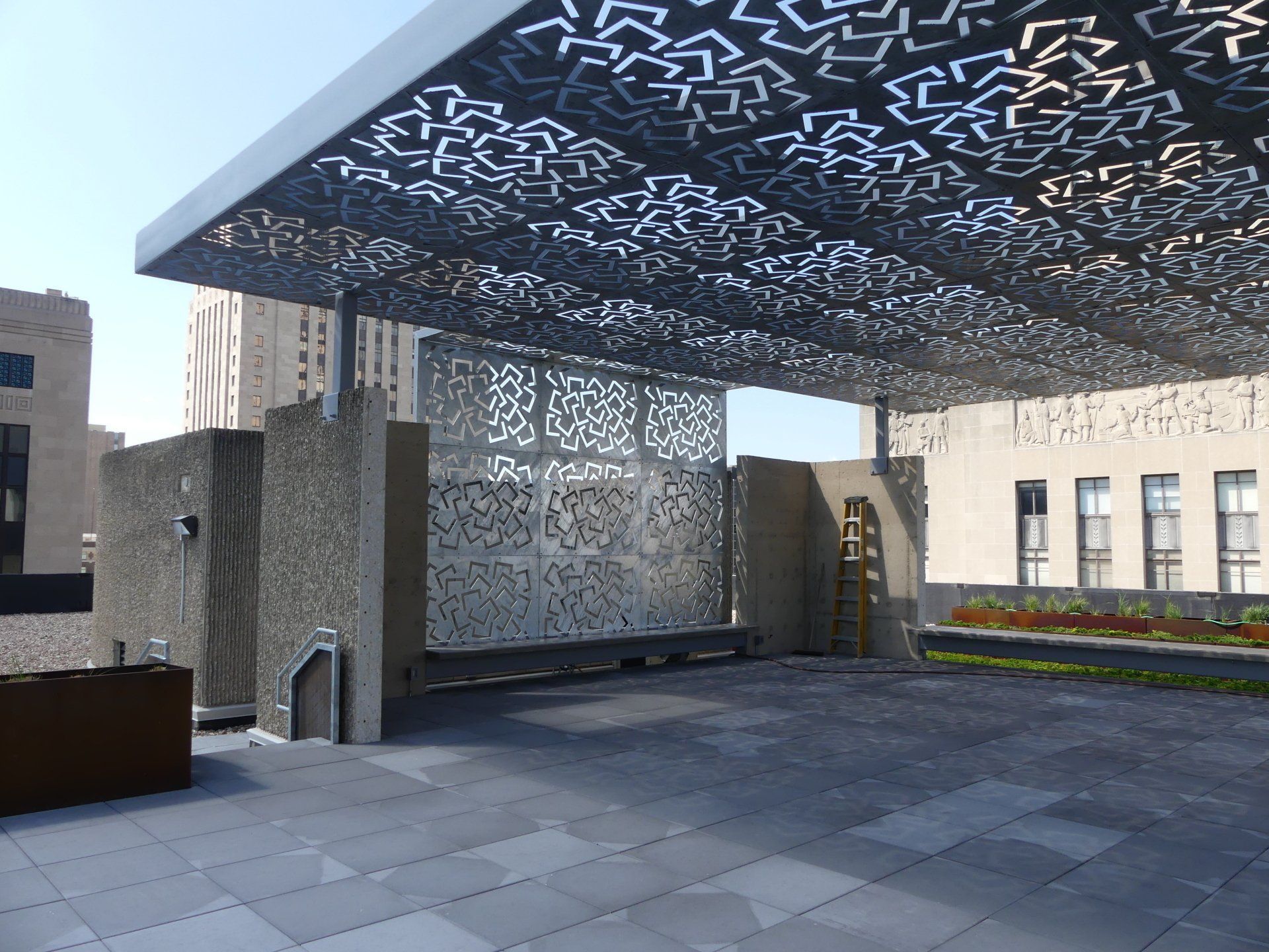 A patio with a canopy over it and a building in the background