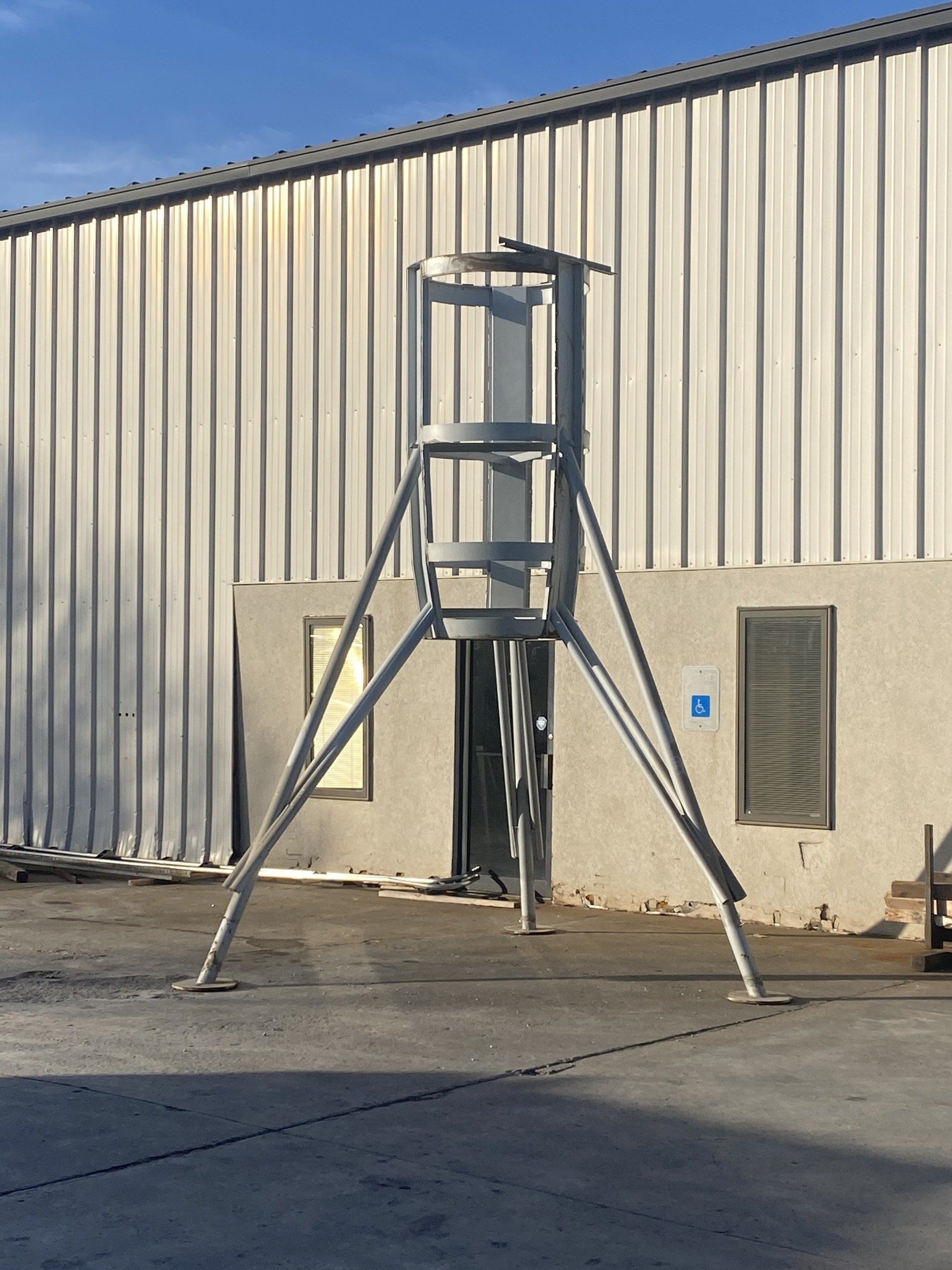 A metal ladder is sitting in front of a building