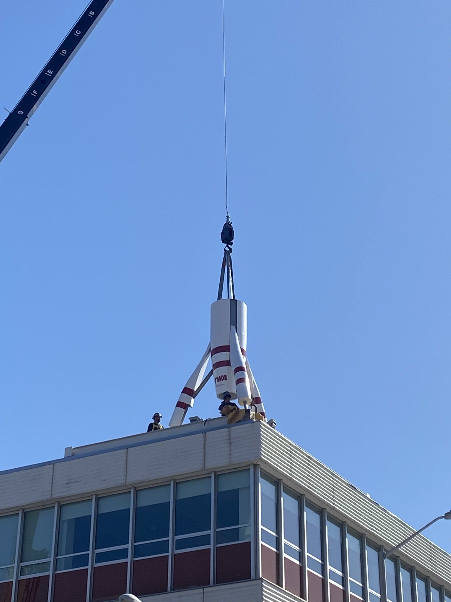 A large building with a crane on top of it