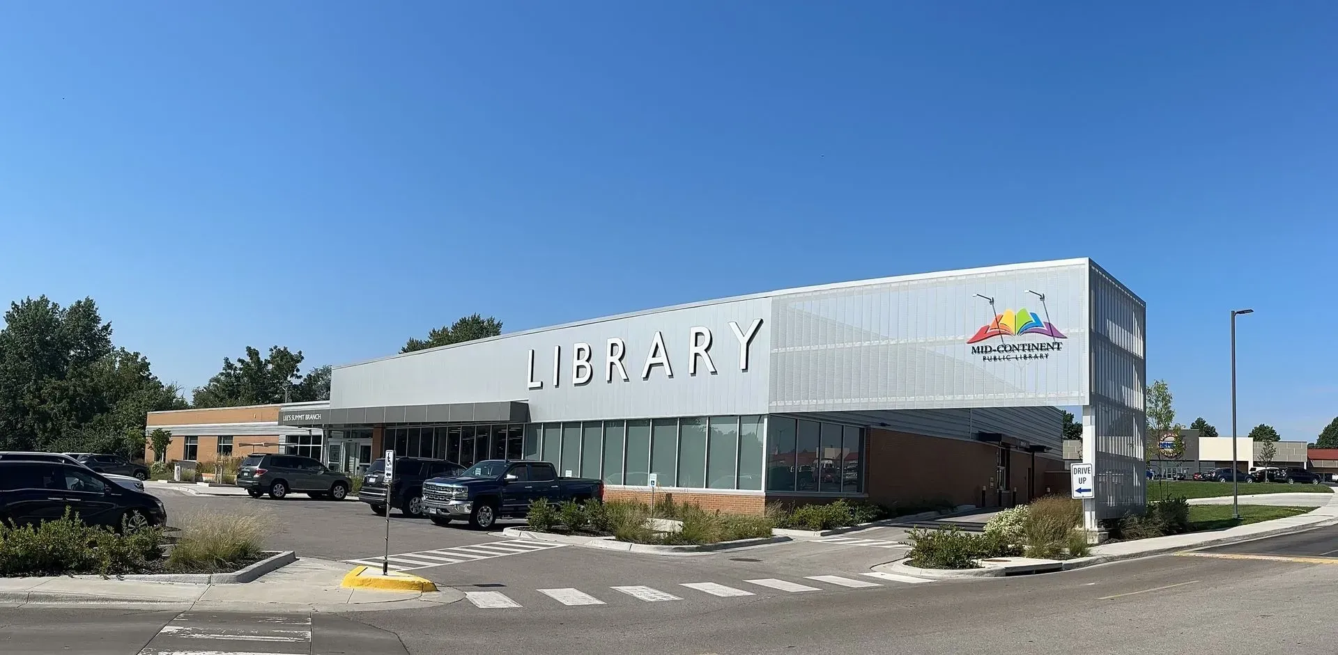 A single-story library building under a clear blue sky. 
