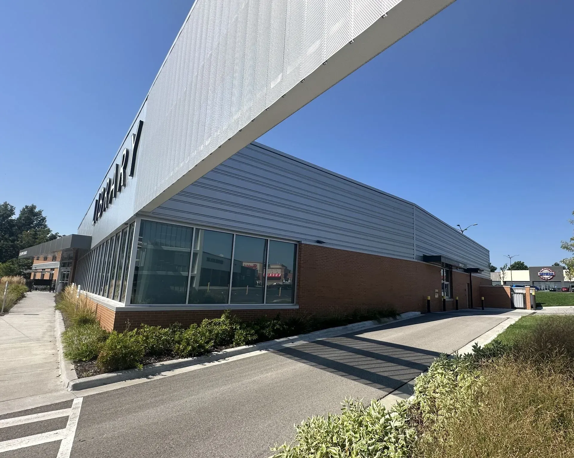 Exterior view of a modern building with a large, white overhang.